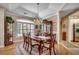 Elegant dining room featuring hardwood floors, a chandelier, and a china cabinet for storage at 4363 Parkland Dr., Myrtle Beach, SC 29579