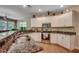 Well-lit kitchen featuring white cabinets, granite countertops, stainless steel appliances and hardwood floors at 4363 Parkland Dr., Myrtle Beach, SC 29579
