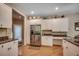 Open kitchen with stainless steel refrigerator, granite counters, hardwood floors and ample storage at 4363 Parkland Dr., Myrtle Beach, SC 29579