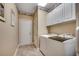 Bright laundry room with white cabinets, tile flooring, and modern appliances for efficient laundry tasks at 4363 Parkland Dr., Myrtle Beach, SC 29579
