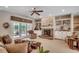 Bright living room with built-in shelves, a brick fireplace, and French doors to outdoor space at 4363 Parkland Dr., Myrtle Beach, SC 29579