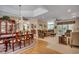 Spacious living room with carpeted and hardwood floors, a dining table, and cozy seating arrangements at 4363 Parkland Dr., Myrtle Beach, SC 29579