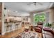 Living area with hardwood floors, kitchen bar seating, and access to dining area with bay windows at 4363 Parkland Dr., Myrtle Beach, SC 29579