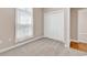 Bedroom with carpet, closet, and ample natural light from the large window at 442 Mahogany Dr. # 101, Murrells Inlet, SC 29576