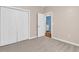 Bright bedroom with closet and doorway, complete with carpet flooring and neutral paint at 442 Mahogany Dr. # 101, Murrells Inlet, SC 29576