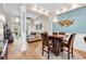 Open concept dining room showcasing modern lighting fixtures, wood floors, and plenty of space at 442 Mahogany Dr. # 101, Murrells Inlet, SC 29576