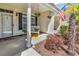 Inviting front porch with a white bench, hanging flower baskets, and an American flag at 442 Mahogany Dr. # 101, Murrells Inlet, SC 29576