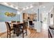 Modern kitchen flows into the dining area, with warm lighting and plenty of room for seating at 442 Mahogany Dr. # 101, Murrells Inlet, SC 29576