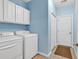 Convenient laundry room with washer, dryer, and cabinets for storage, providing easy access at 442 Mahogany Dr. # 101, Murrells Inlet, SC 29576