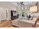 Cozy living room featuring a ceiling fan, hardwood floors, comfortable seating, and access to the screened porch at 442 Mahogany Dr. # 101, Murrells Inlet, SC 29576