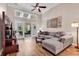 Bright living room boasts a ceiling fan, wood floors, neutral colors, and sliding door access to the screened in porch at 442 Mahogany Dr. # 101, Murrells Inlet, SC 29576
