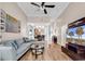 This open-concept living room includes hardwood floors, natural light, and comfortable gray couches, perfect for gatherings at 442 Mahogany Dr. # 101, Murrells Inlet, SC 29576