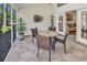 Relaxing screened porch featuring a dining table, outdoor seating, tile floor, and access to the backyard at 442 Mahogany Dr. # 101, Murrells Inlet, SC 29576