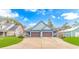 Beautiful light blue home featuring a wide driveway and a symmetrical two-car garage at 460 Boundary Ave. # A & B, Murrells Inlet, SC 29576