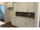 Modern kitchen with white cabinets, stainless steel appliances, and dark backsplash at 4762 Huckleberry Ln., Conway, SC 29526