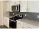 Modern kitchen design with white cabinetry, quartz countertops, and stainless steel appliances at 4762 Huckleberry Ln., Conway, SC 29526