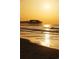 Scenic view of the pier at sunrise with calm ocean waves and golden light, creating a peaceful atmosphere at 4762 Huckleberry Ln., Conway, SC 29526