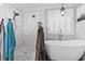 Luxurious bathroom with freestanding tub, glass shower, and elegant fixtures with marble tile surround at 4862 Mill Pond Rd., Myrtle Beach, SC 29588