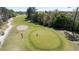 Picturesque golf course view featuring lush green fairways, mature trees, and a sand bunker with players on the green at 492 Sun Colony Blvd., Longs, SC 29568