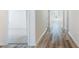 Bright hallway with wood floors leading to carpeted bedrooms with natural light at 492 Sun Colony Blvd., Longs, SC 29568
