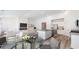 Open-concept living space featuring a modern kitchen, dining area, and cozy living room with fireplace at 492 Sun Colony Blvd., Longs, SC 29568