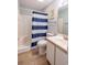 Neat bathroom featuring a shower-tub combo and a white vanity sink and wood-look floor at 5000 Windsor Green Way # 102, Myrtle Beach, SC 29579