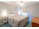Light-filled bedroom with bed, side tables, lamps, and a charming quilt, exudes a cozy and inviting ambiance at 5000 Windsor Green Way # 102, Myrtle Beach, SC 29579