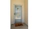 Close-up of the front door with glass screen, brass hardware, and 'hello' welcome mat at 5000 Windsor Green Way # 102, Myrtle Beach, SC 29579