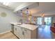 Open kitchen with quartz counters, white cabinets, and a view of the dining and living areas at 5000 Windsor Green Way # 102, Myrtle Beach, SC 29579
