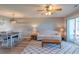 Open living room & dining area with neutral sofa, wood floors and a sliding door to patio at 5000 Windsor Green Way # 102, Myrtle Beach, SC 29579