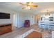 Inviting living room features wood floors, ceiling fan, and seamless flow into the dining area and kitchen at 5000 Windsor Green Way # 102, Myrtle Beach, SC 29579