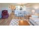 Open floor plan showcasing living room, dining area, and kitchen, with wood flooring and neutral decor at 5000 Windsor Green Way # 102, Myrtle Beach, SC 29579