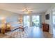 Bright living room with sliding glass doors, ceiling fan, neutral paint and wood laminate flooring at 5000 Windsor Green Way # 102, Myrtle Beach, SC 29579
