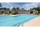 Expansive community pool with clear blue water, sun loungers, and nearby buildings at 5000 Windsor Green Way # 102, Myrtle Beach, SC 29579