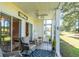 Relaxing screened porch featuring a ceiling fan, seating, and views of the golf course and pond at 5000 Windsor Green Way # 102, Myrtle Beach, SC 29579