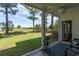 Open screened porch with ceiling fan and seating, overlooking a golf course and blue skies at 5000 Windsor Green Way # 102, Myrtle Beach, SC 29579