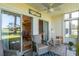 Inviting screened-in porch with ceiling fan, rocking chair, and comfortable seating overlooking the outdoors at 5000 Windsor Green Way # 102, Myrtle Beach, SC 29579