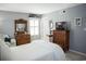 Spacious bedroom with a comfortable bed, vintage wood dresser, and ample natural light creating a relaxing atmosphere at 501 44Th Ave. N # D 9, Myrtle Beach, SC 29577