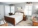 Cozy bedroom featuring light gray walls, hardwood floors, and natural lighting from the large windows with white wood shutters at 501 44Th Ave. N # D 9, Myrtle Beach, SC 29577