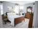 Well-lit bedroom with an antique wooden bed frame, vintage furniture, and light gray walls giving the space a light and airy feel at 501 44Th Ave. N # D 9, Myrtle Beach, SC 29577