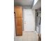 Hallway with neutral-colored tile flooring featuring a storage cabinet and a white interior door at 501 44Th Ave. N # D 9, Myrtle Beach, SC 29577