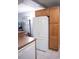 View of the kitchen with a white refrigerator, wooden cabinets, and an adjacent dining area at 501 44Th Ave. N # D 9, Myrtle Beach, SC 29577