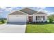 Charming single-story home featuring a light gray facade, attached garage, and well-maintained front lawn at 509 Blissful Ln., Little River, SC 29566