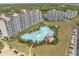 Aerial view featuring a luxury pool and resort amenities, surrounded by condos at 5111 Double Eagle Way # 3, North Myrtle Beach, SC 29582
