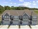 Aerial view of townhomes with gray siding, brown roofs, and manicured lawns at 5111 Double Eagle Way # 3, North Myrtle Beach, SC 29582