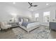 Bright bedroom with large bed, decorative pillows, modern ceiling fan, and stylish decor at 5111 Double Eagle Way # 3, North Myrtle Beach, SC 29582
