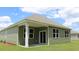 A covered back porch with white posts and sliding glass doors at 519 Blissful Ln., Little River, SC 29566