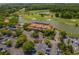Aerial of golf course and clubhouse with parking, water features, and landscaping at 5801 Oyster Catcher Dr. # 1214, North Myrtle Beach, SC 29582