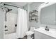 Clean bathroom with white fixtures, a shower with a curtain, and a modern vanity with shelving at 5801 Oyster Catcher Dr. # 1214, North Myrtle Beach, SC 29582