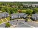 Exterior view of condo building with parking, palm trees, and well-maintained landscaping at 5801 Oyster Catcher Dr. # 1214, North Myrtle Beach, SC 29582